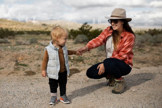 Full shot mother and child in american desert