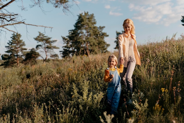 Full shot mother and girl holding hands