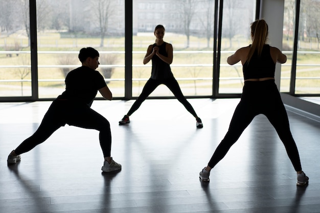 Full shot people in barre group class