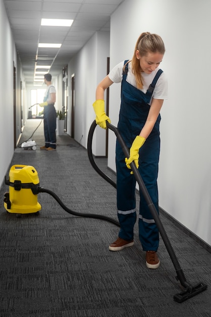 Full shot people cleaning building