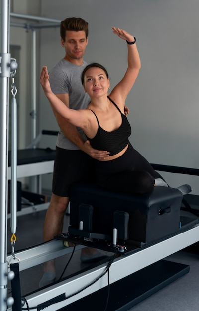 Full shot people doing pilates