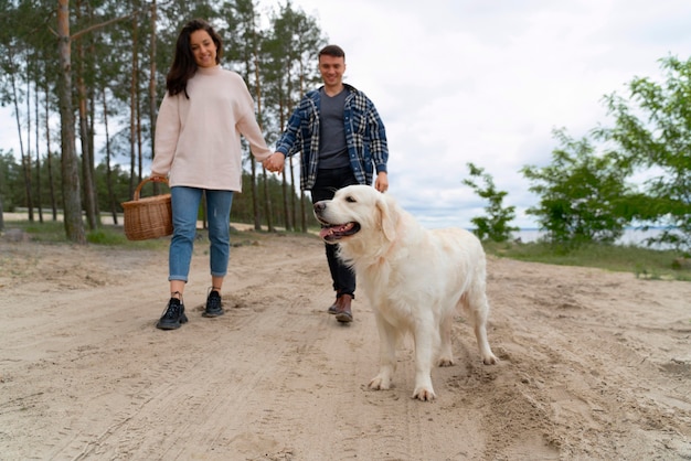 Full shot people walking with dog