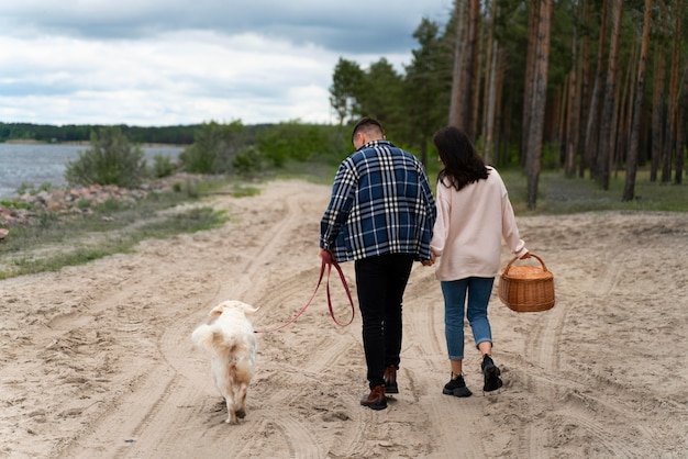 Full shot people with dog at beach