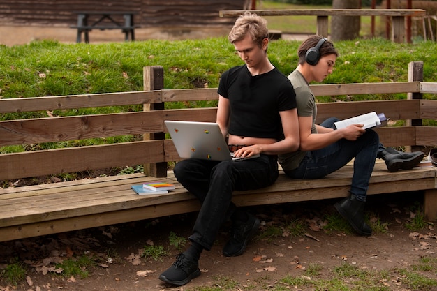 Full shot queer students outdoors