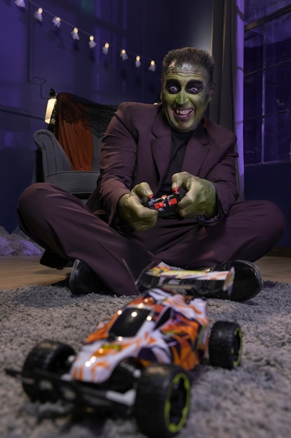 Full shot smiley frankenstein playing with car