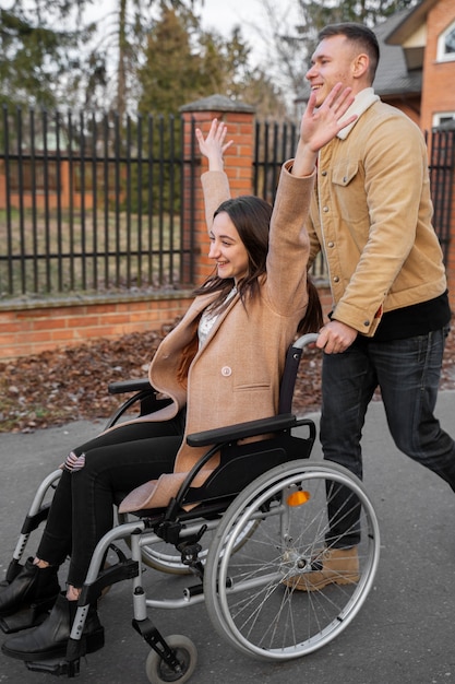 Full shot smiley man helping disabled friend