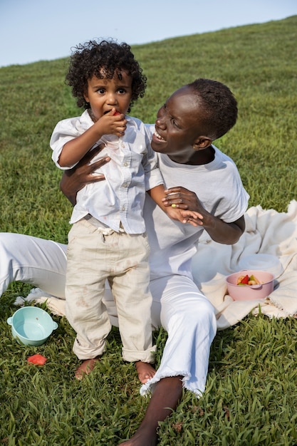 Full shot smiley mother and kid outdoors