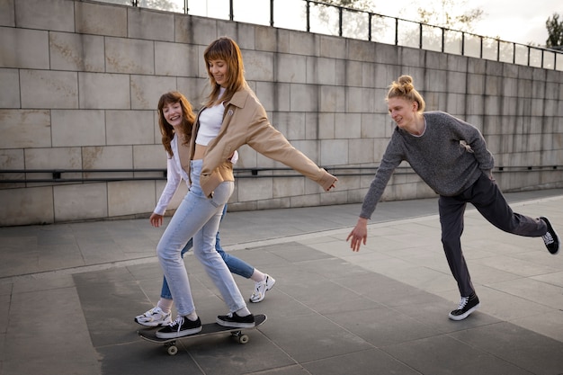 Full shot smiley people on skateboard