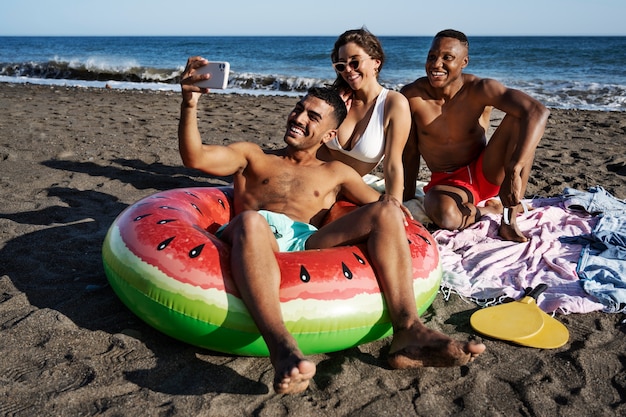 Full shot smiley people taking selfie