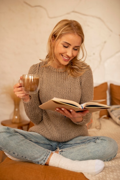 Full shot smiley woman reading