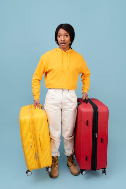 Full shot woman carrying baggage