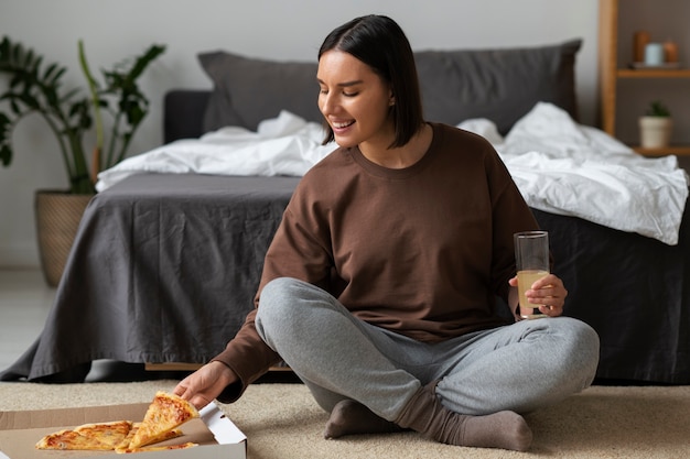 Full shot woman eating delicious pizza