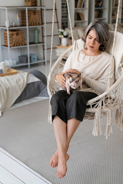 Full shot woman holding cat