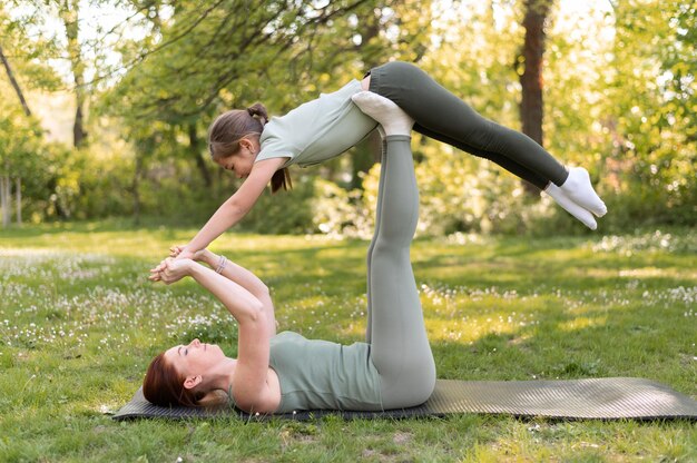 Full shot woman holding girl up