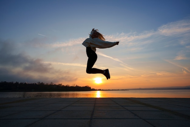 Full shot woman posing at sunset