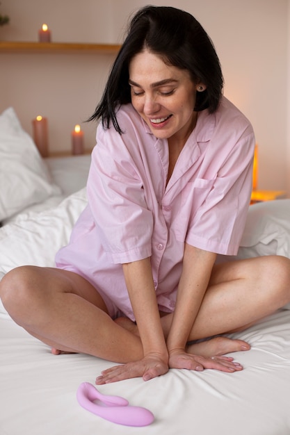 Full shot woman posing with vibrator