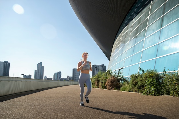 Full shot woman running outdoors