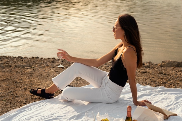 Full shot woman sitting outdoors