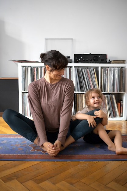 Full shot woman stretching indoors