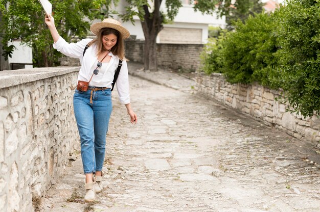 Full shot woman walking on alley