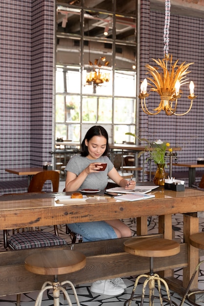 Full shot woman with coffee cup