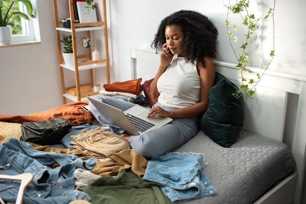 Full shot woman with laptop in bed