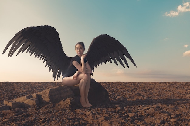 Full shot woman with wings outdoors