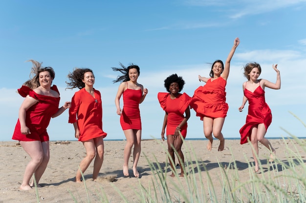 Full shot women having fun at beach