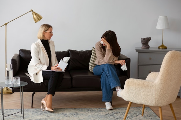 Full shot young woman undergoing therapy