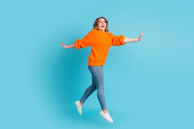 Full size photo of cool brunette millennial lady jump isolated on green turquoise color background