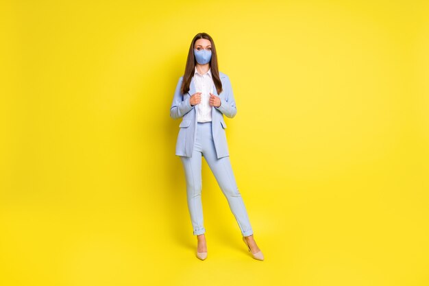 Full size photo executive marketer girl work office protect safe medical mask wear blazer trousers high-heels stilettos isolated bright shine color background