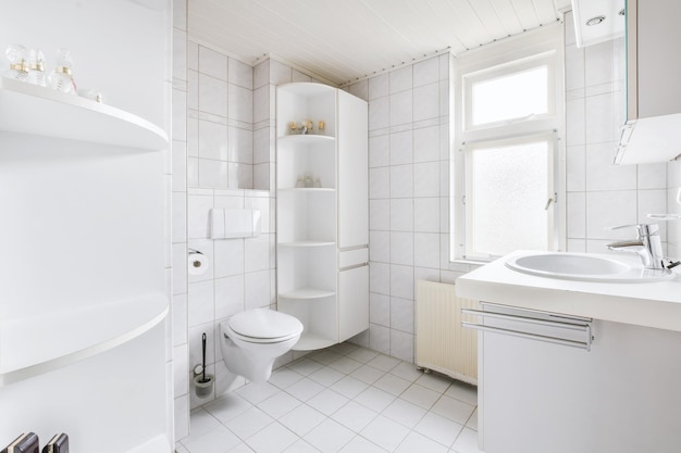 Full white bathroom with bathroom shelves in the corner