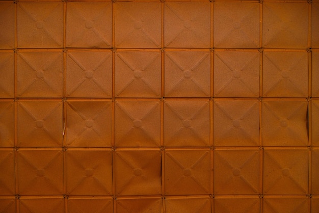 Photo fullframe background and texture of square stamped sheet metal tiles with diagonal ribs