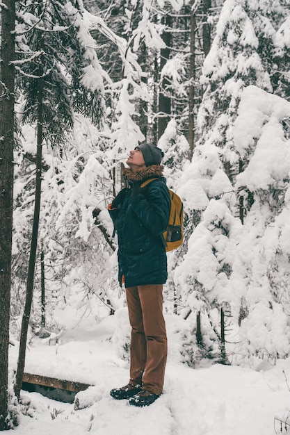 Fulllength image of man in winter forest