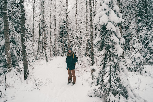 Fulllength photo of tourist man in winter forest