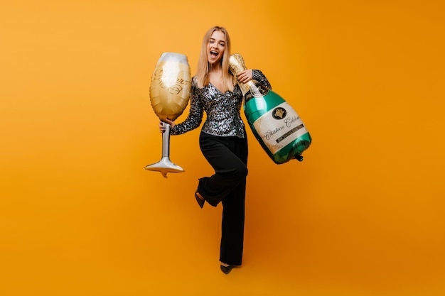 Fulllength portrait of pleasant white girl expressing positive emotions at party Wonderful elegant woman dancing with wineglass