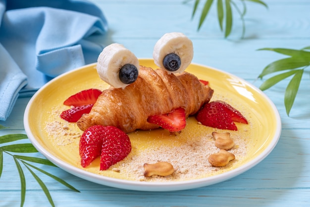 Fun Food for kids. Cute crab croissant with fruit for kids breakfast