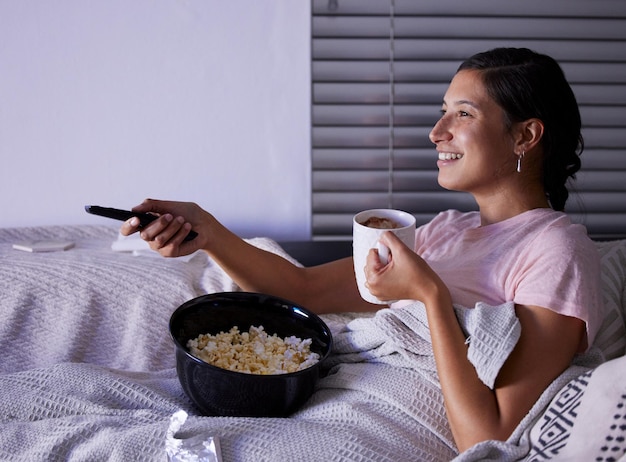 A fun night in Shot of a young woman watching tv at home