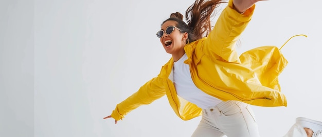 Photo fun young woman in yellow jacket jumping and laughing isolated on white background generative ai