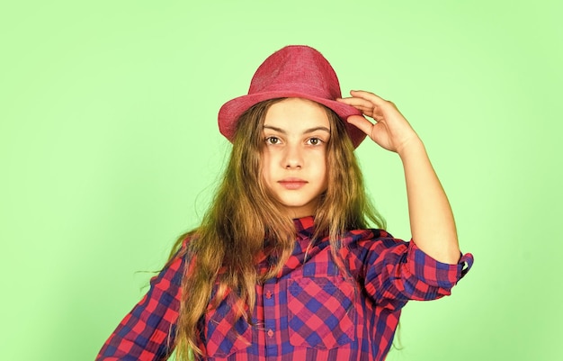 Funky beauty happy childhood small girl follow latest trends pure and natural beauty child has long hair hipster girl wear retro hat stylish kid looking retro checkered fashion for teen