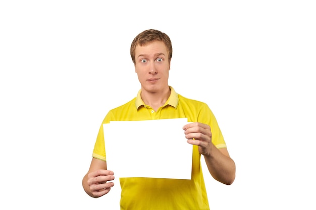 Funny attractive guy holding blank paper sheet paper mockup isolated on white background