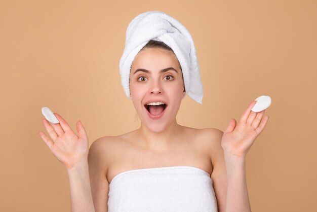 Funny beautiful girl with a towel on head facial treatment cosmetology beauty and spa