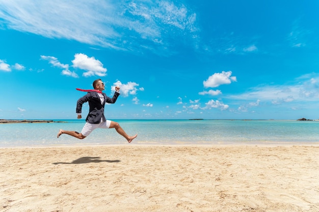 Funny businessman runs from office work on the beach Summer holiday concept