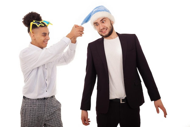 Funny Caucasian and American guys in formal wear with big star glasses and a Santa hat