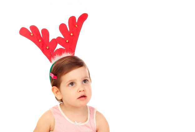 Funny child wearing christmas reindeer horns