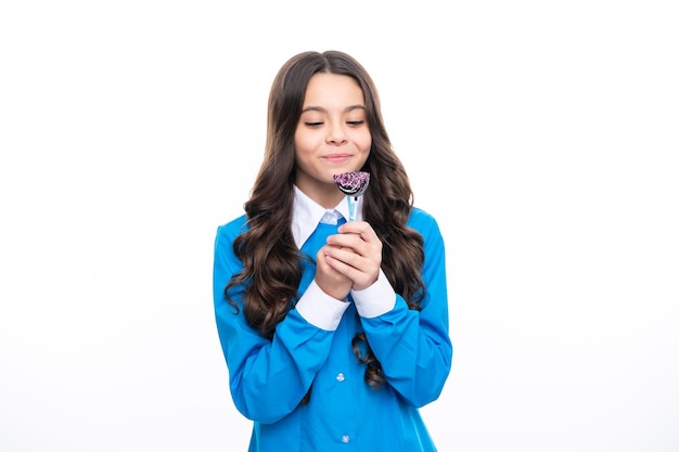 Funny child with lollipop over white isolated background Sweet childhood life Teen girl with yummy caramel lollipop candy shop Teenager with sweet sucker