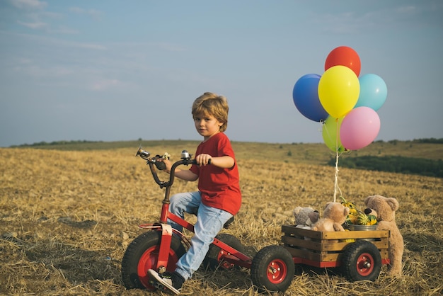 Funny child with vintage bike in a country road travel and vacation concept child dream of traveling