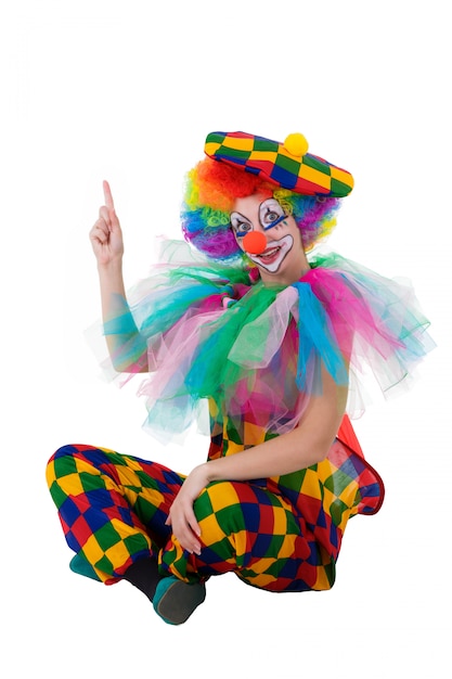 Funny clown pointing happily upward onto copy space