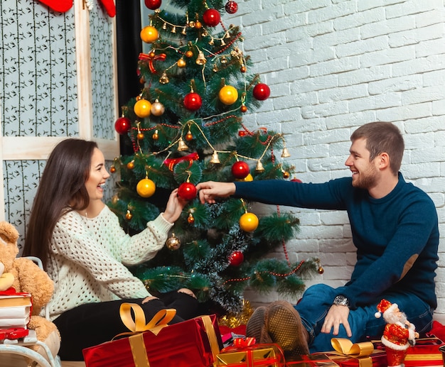 Funny couple celebrates Christmas. New Year.