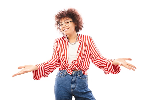 Funny curly girl shrugging hands thinks doubts makes decision isolated on white studio background